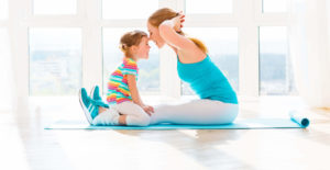 happy mum exercising with child