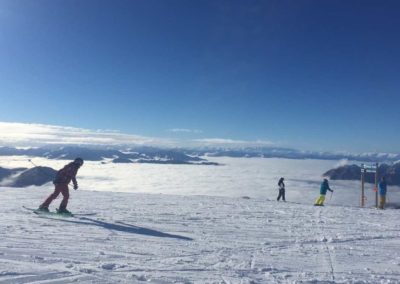 People in the back ground are at the edge of the snow